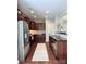 Open kitchen with stainless steel appliances and stylish dark wood cabinets at 1673 Beleek Ridge Ln, Clover, SC 29710
