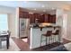 Open kitchen features stainless steel appliances, dark wood cabinets, and a bar with seating at 1673 Beleek Ridge Ln, Clover, SC 29710