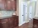 Kitchen featuring dark wood cabinets, stainless steel appliances, and a pantry door at 1673 Beleek Ridge Ln, Clover, SC 29710