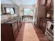 Well-lit kitchen with dark wood cabinets, stainless steel appliances, and adjacent dining area at 1673 Beleek Ridge Ln, Clover, SC 29710