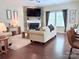 Bright living room features a stone fireplace, ceiling fan, and large windows at 1673 Beleek Ridge Ln, Clover, SC 29710