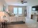 Bright main bedroom with a king bed, two windows, and a mounted television above a rustic table at 1673 Beleek Ridge Ln, Clover, SC 29710
