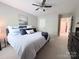 Spacious main bedroom featuring a ceiling fan, a bed, and a large window for natural light at 1673 Beleek Ridge Ln, Clover, SC 29710