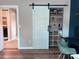 Office featuring custom barn door, hardwood floors, and shelving for storage at 1673 Beleek Ridge Ln, Clover, SC 29710