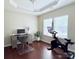 Bright office space featuring hardwood floors, a modern desk, and an exercise bike for a balanced lifestyle at 1673 Beleek Ridge Ln, Clover, SC 29710