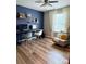 Bright office with modern decor, stylish blue accent wall, and hardwood floors at 1673 Beleek Ridge Ln, Clover, SC 29710