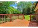 Charming wooden deck overlooking a beautiful backyard with lush greenery and mature trees at 1713 Andover Nw St, Concord, NC 28027