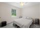 Cozy bedroom with neutral walls, plush carpet, and a large window at 1713 Andover Nw St, Concord, NC 28027