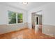 Bright dining room features hardwood flooring, neutral paint, and a large window providing ample natural light at 1713 Andover Nw St, Concord, NC 28027