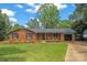 Charming one-story brick home featuring a well-manicured lawn, black shutters, and an attached single-car garage at 1713 Andover Nw St, Concord, NC 28027