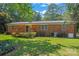 Back exterior of the brick home with wooden deck and grassy lawn at 1713 Andover Nw St, Concord, NC 28027