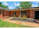 Brick home exterior features a walkway with landscaped mulch beds, and a partial view of the yard at 1713 Andover Nw St, Concord, NC 28027