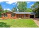 Charming one-story brick home featuring a well-manicured lawn, black shutters, and an attached single-car garage at 1713 Andover Nw St, Concord, NC 28027
