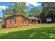 Charming brick home featuring a well-manicured lawn and a freshly sealed driveway at 1713 Andover Nw St, Concord, NC 28027