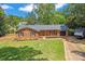 Charming brick home featuring a well-manicured lawn and a freshly sealed driveway at 1713 Andover Nw St, Concord, NC 28027