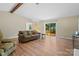 Comfortable living room featuring hardwood floors, a ceiling fan, sliding glass door, and cozy seating at 1713 Andover Nw St, Concord, NC 28027