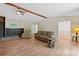 Open-concept living room with hardwood floors, ceiling fan, comfortable seating, and access to other rooms at 1713 Andover Nw St, Concord, NC 28027