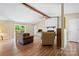 Inviting living room with hardwood floors, a white brick fireplace, ceiling fan, and sliding glass doors to the deck at 1713 Andover Nw St, Concord, NC 28027