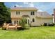 Spacious backyard featuring a wooden deck, lush green lawn, and mature landscaping, ideal for outdoor enjoyment at 2019 Steeplechase Dr, Rock Hill, SC 29732