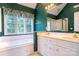A bright bathroom featuring green walls, vanity, tub, window, and walk-in shower at 2019 Steeplechase Dr, Rock Hill, SC 29732