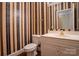 Full bathroom featuring a toilet, vanity, mirror, decorative wallpaper and hardwood floors at 2019 Steeplechase Dr, Rock Hill, SC 29732