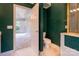 View into bathroom featuring an open doorway and green wallpaper, along with toilet, vanity, and walk-in shower at 2019 Steeplechase Dr, Rock Hill, SC 29732