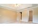 Neutral bedroom featuring a ceiling fan, carpeted floor, and a door leading to an en-suite bathroom and walk-in closet at 2019 Steeplechase Dr, Rock Hill, SC 29732