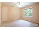 Neutral carpeted bedroom with a window and a ceiling fan at 2019 Steeplechase Dr, Rock Hill, SC 29732