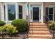 Inviting front entrance with brick steps, wrought iron railings, and manicured landscaping at 2019 Steeplechase Dr, Rock Hill, SC 29732