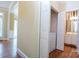 Hallway area featuring hardwood floors, leading to a half bath, and including a laundry closet with a washer and dryer unit at 2019 Steeplechase Dr, Rock Hill, SC 29732