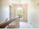 Upstairs hallway with carpet, traditional lighting fixture, and arch window view at 2019 Steeplechase Dr, Rock Hill, SC 29732