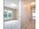 Hallway view with beige walls and carpet, leading to rooms filled with natural light from the windows at 2019 Steeplechase Dr, Rock Hill, SC 29732