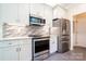 Modern kitchen featuring stainless steel appliances, gray cabinets, and stylish backsplash at 2019 Steeplechase Dr, Rock Hill, SC 29732