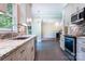 Updated kitchen with stainless steel appliances, granite countertops, and a view of the living room at 2019 Steeplechase Dr, Rock Hill, SC 29732