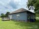 Rear exterior featuring a wood deck and well-maintained lawn at 210 Rhyne St, Stanley, NC 28164