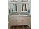 Bathroom vanity features white cabinets, double sinks, granite countertop, and attractive vanity mirrors at 210 Rhyne St, Stanley, NC 28164