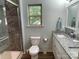 Bathroom features a glass enclosed shower, granite vanity, and light blue paint at 210 Rhyne St, Stanley, NC 28164