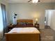 Carpeted bedroom with ceiling fan, natural light, and warm colored walls offer a cozy and inviting space at 210 Rhyne St, Stanley, NC 28164