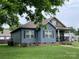 Attractive blue home with neatly kept lawn and classic architectural details at 210 Rhyne St, Stanley, NC 28164