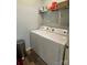 Efficient laundry area featuring a side-by-side washer and dryer set and ample shelving at 210 Rhyne St, Stanley, NC 28164