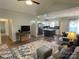 Open-concept living area with sleek hardwood floors, modern lighting, and a cozy atmosphere at 210 Rhyne St, Stanley, NC 28164