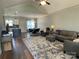 Inviting living room featuring a rug, modern ceiling fan, and an open layout at 210 Rhyne St, Stanley, NC 28164