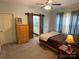 Bedroom with natural light, sliding barn doors to bathroom and closet, ceiling fan, and neutral carpet at 210 Rhyne St, Stanley, NC 28164