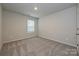 Neutral bedroom offers a bright space, soft carpeting, and a large window for ample light at 2143 Rolling Hills Ct, Stanley, NC 28164
