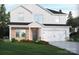 Charming two-story home with a brick and white siding facade and a two car garage in a manicured, landscaped setting at 2143 Rolling Hills Ct, Stanley, NC 28164