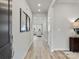 Long hallway with wood floors and neutral walls that leads into a bright living area at 2143 Rolling Hills Ct, Stanley, NC 28164