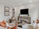Cozy living area with a comfortable sofa, stylish decor, and a large wall-mounted TV for entertainment at 2143 Rolling Hills Ct, Stanley, NC 28164