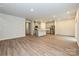 Open-concept living area featuring wood-look flooring, recessed lighting, and a modern kitchen at 2143 Rolling Hills Ct, Stanley, NC 28164