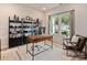 Bright office space featuring a modern desk, shelving, a comfortable chair, and a large window with natural light at 2143 Rolling Hills Ct, Stanley, NC 28164