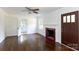 Bright living room featuring hardwood floors, a decorative fireplace, and a ceiling fan at 2628 Clydesdale Ter, Charlotte, NC 28208